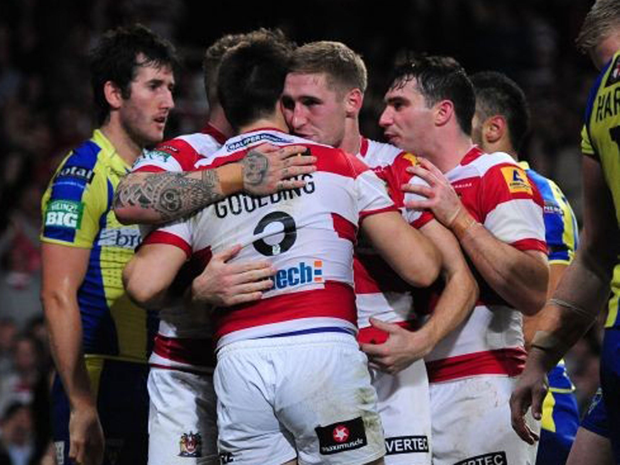 Golden goodbye: Sam Tomkins could not stop Ben Westwood but celebrated Goulding’s try, to young fans’ joy