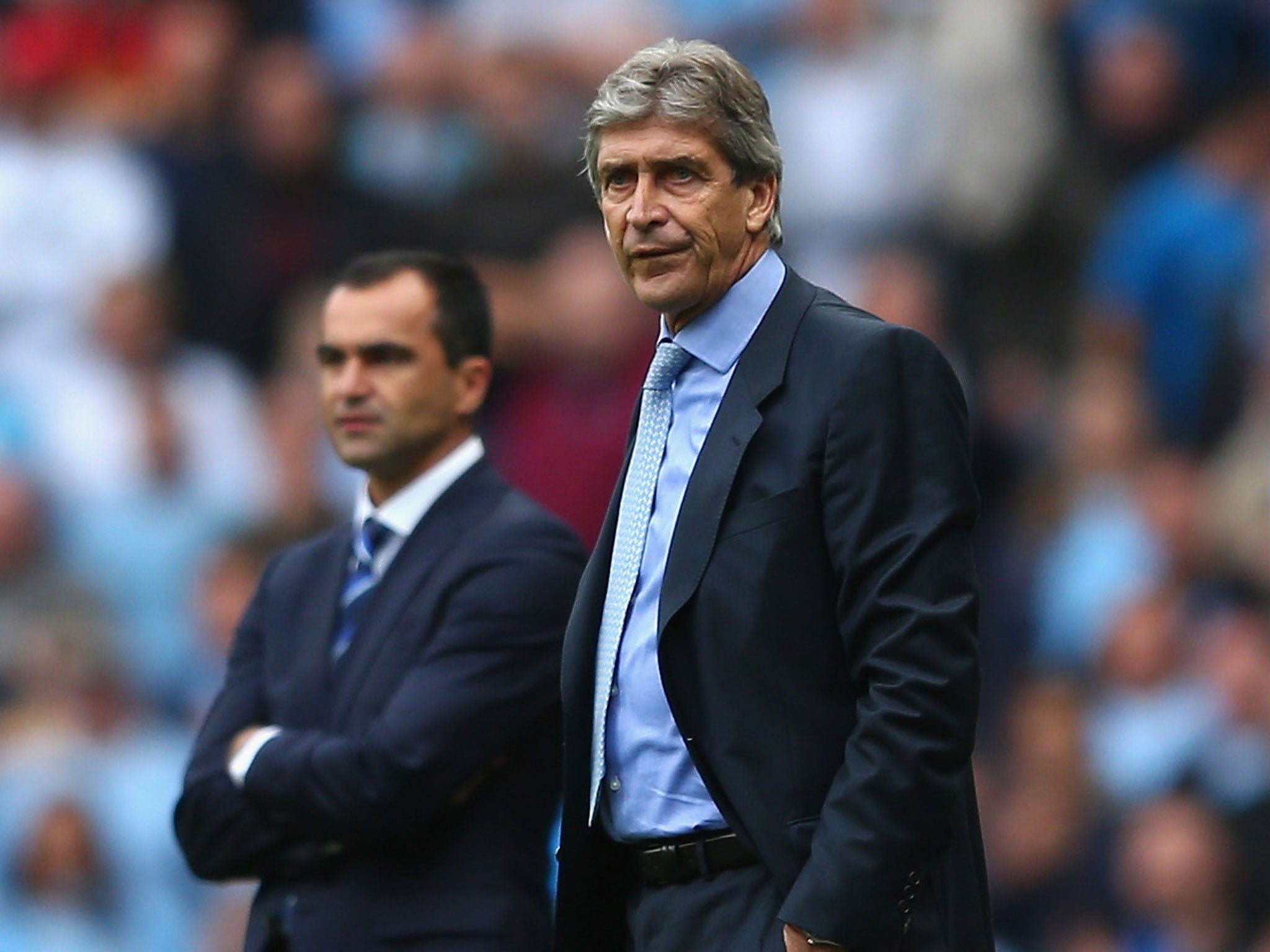 Manuel Pellegrini (right) looks on from the touchline during Manchester City's 3-1 win over Roberto Martinez's (left) Everton