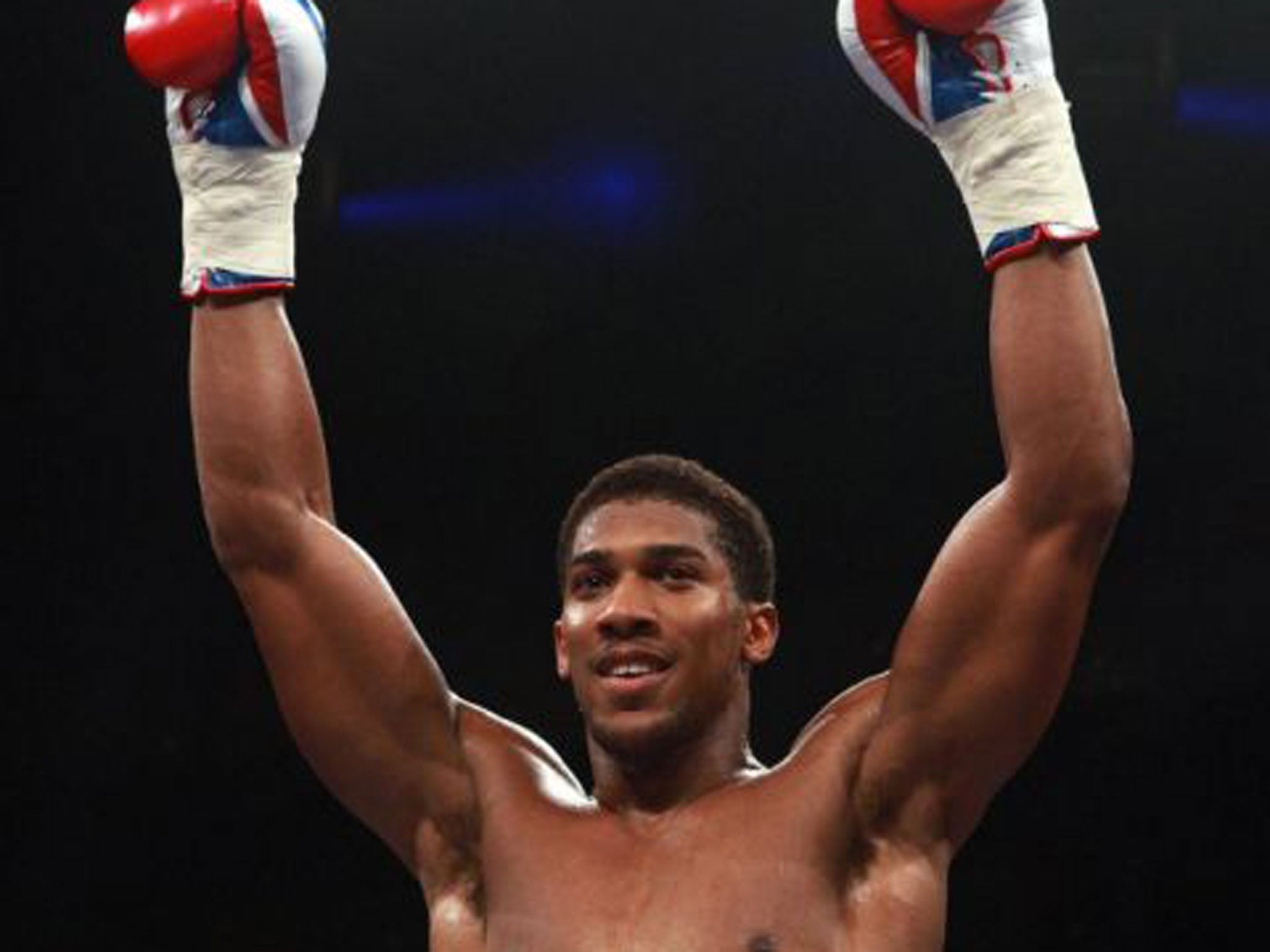 Anthony Joshua celebrates his first-round stoppage on Saturday