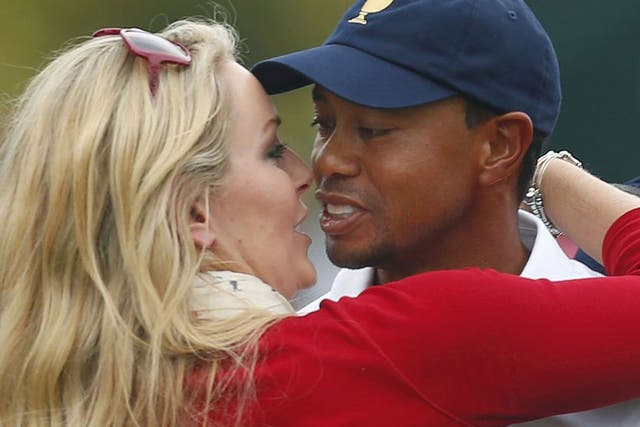 Tiger Woods, right, celebrates with girlfriend Lindsey Vonn