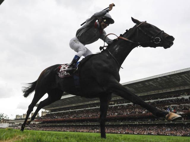 Thierry Jarnet raises his arm in triumph as Treve wins the Arc