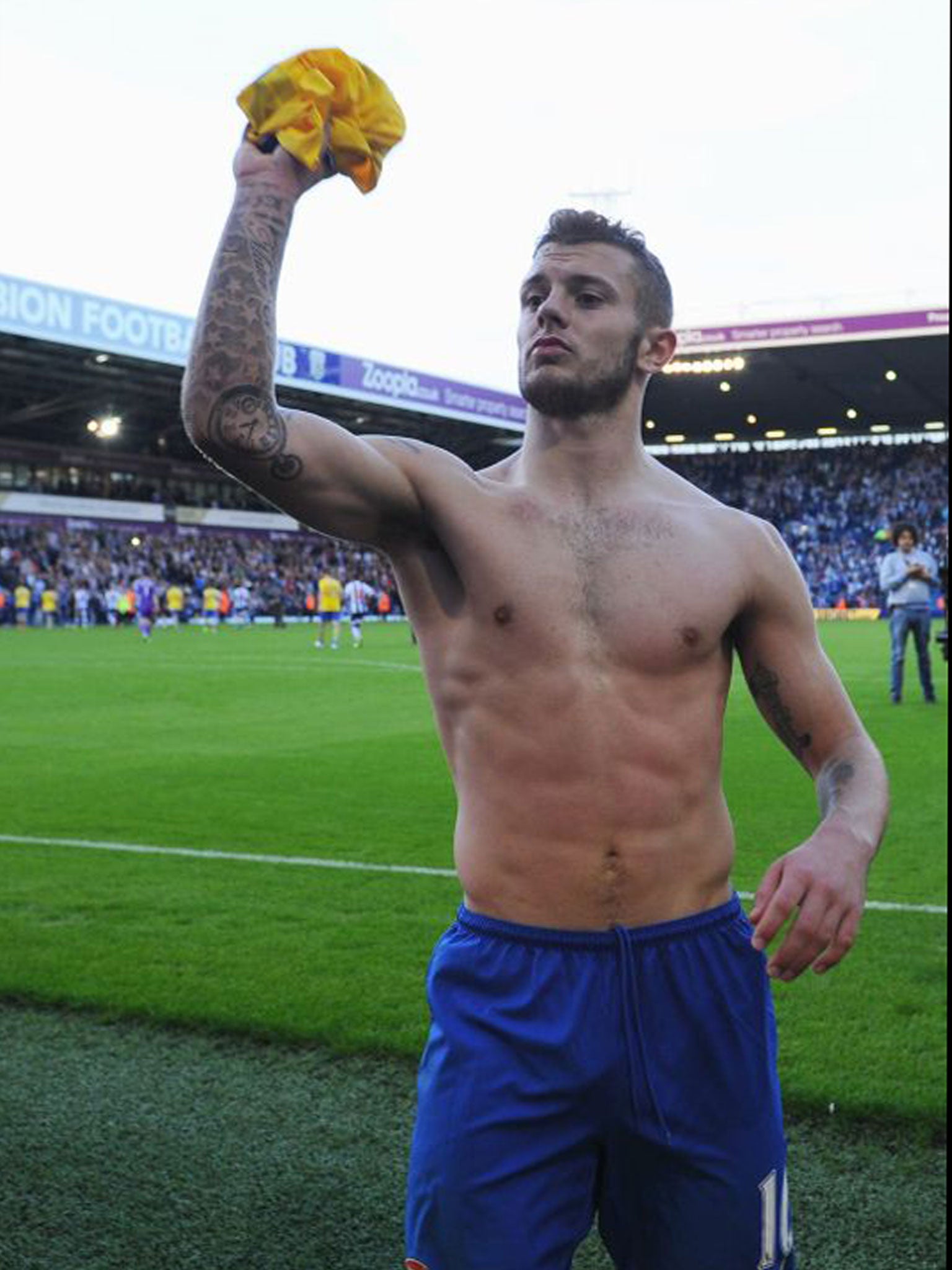 Jack Wilshere throws his shirt into the crowd at The Hawthorns on Sunday