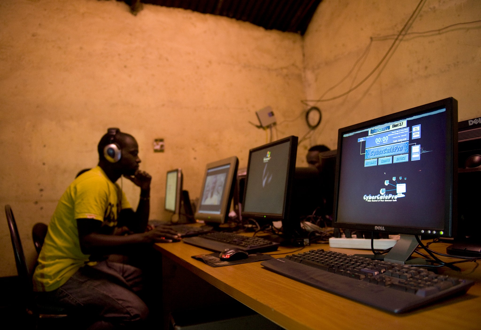 A young man sits at a cyber cafe as he surfs the internet June 20, 2012 in Kibera slum in Nairobi.