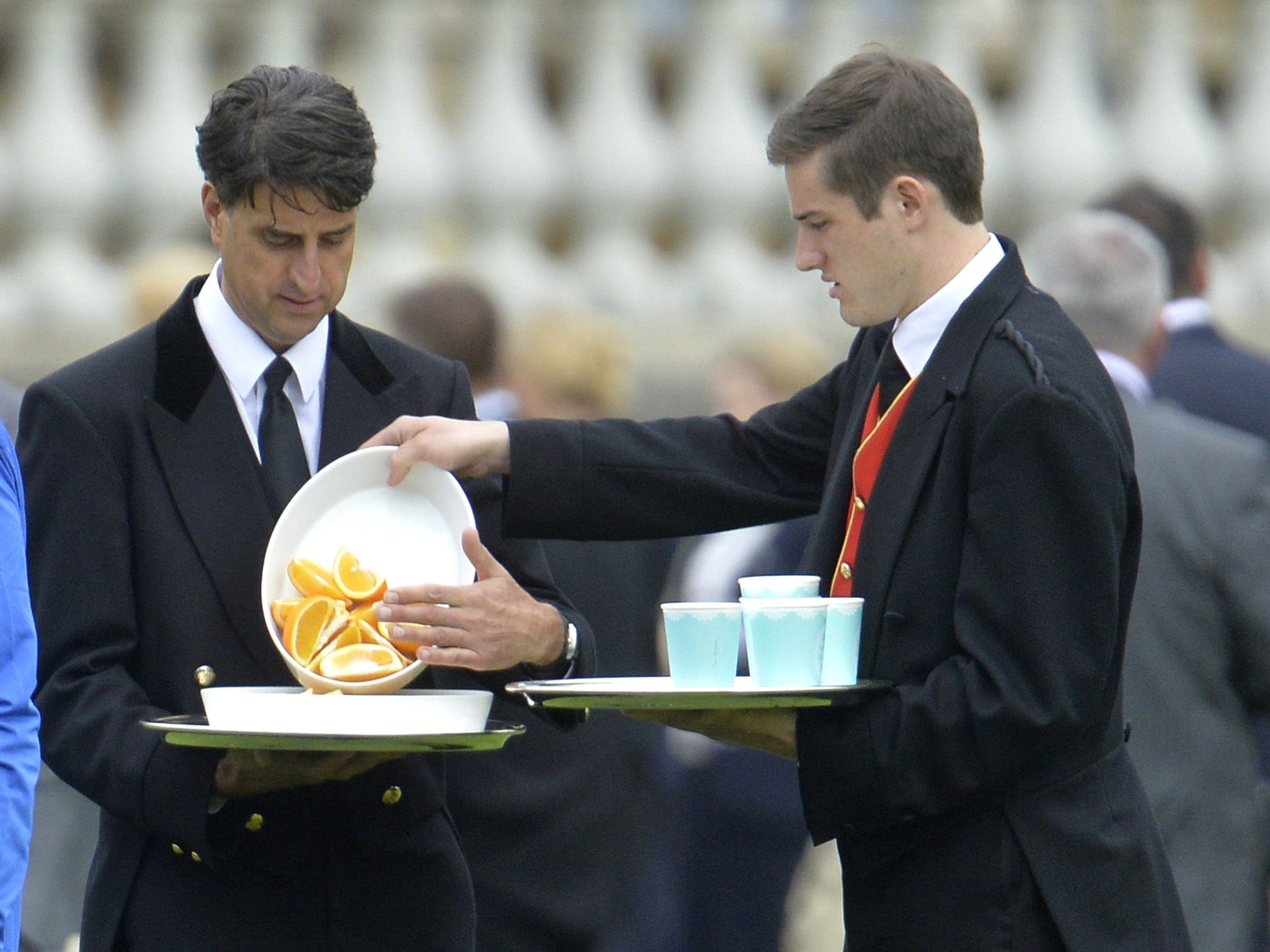 Footmen bring on oranges during the half-time break