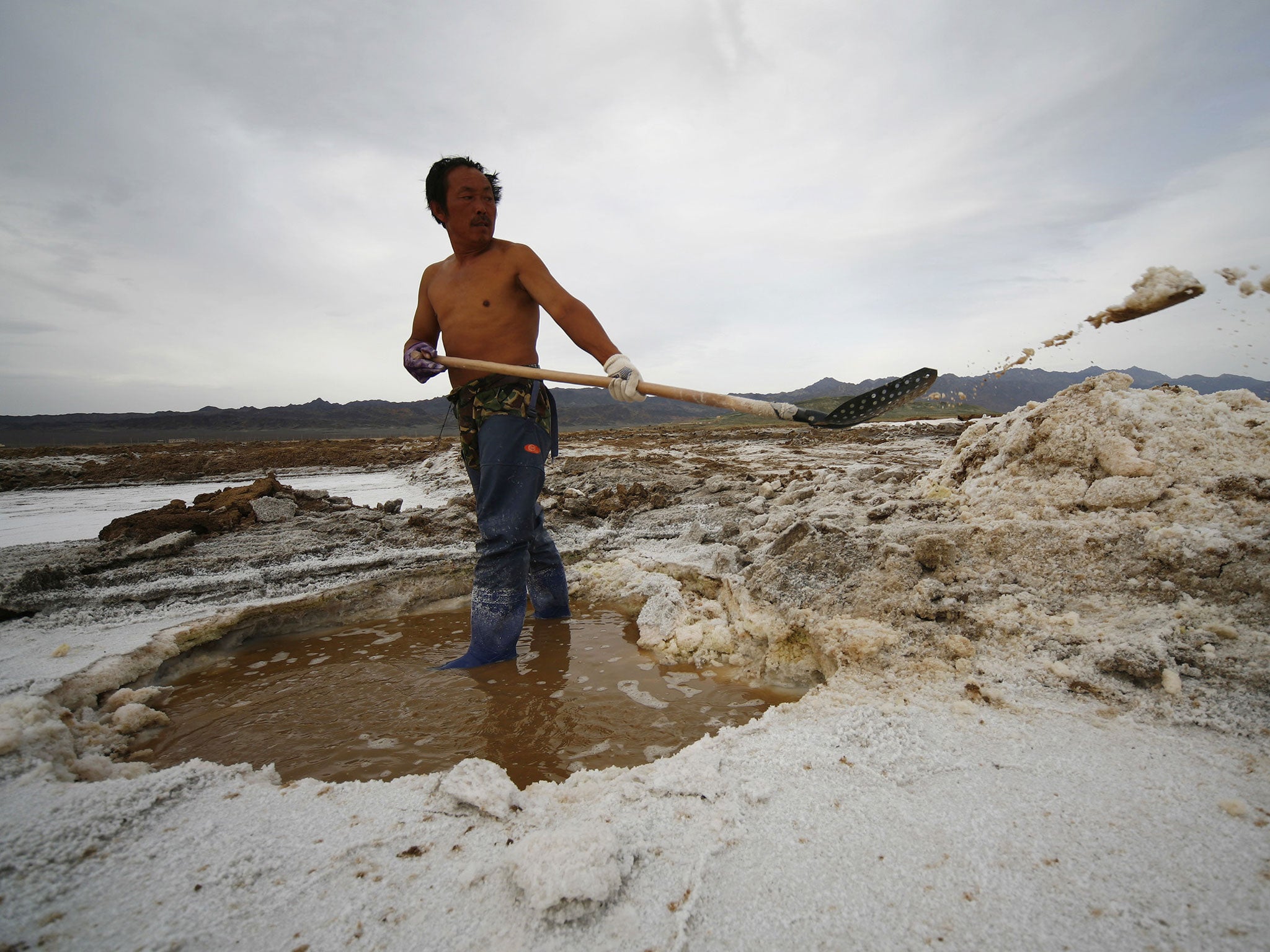 A Chinese labourer working at a saltern in Hami, northwest China's Xinjiang region