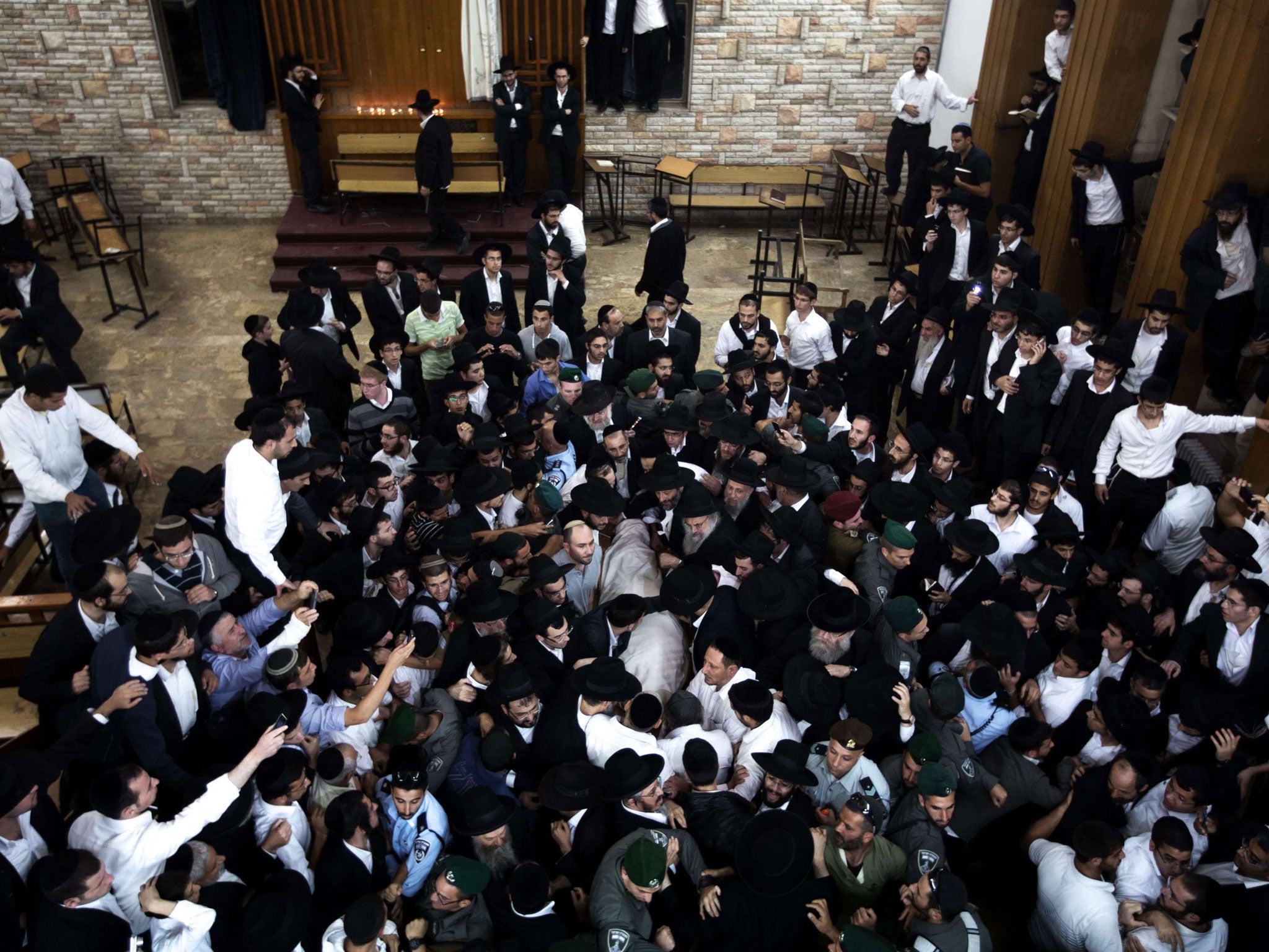 Ultra-orthodox Jewish mourners carry the body of Rabbi Ovadia Yosef during his funeral in Jerusalem