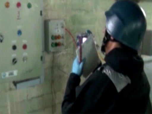 An OPCW inspector at work in Syria on Tuesday