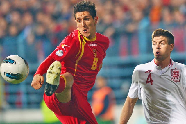 Stevan Jovetic (left) holds off Steven Gerrard during March’s 1-1 draw in Podgorica