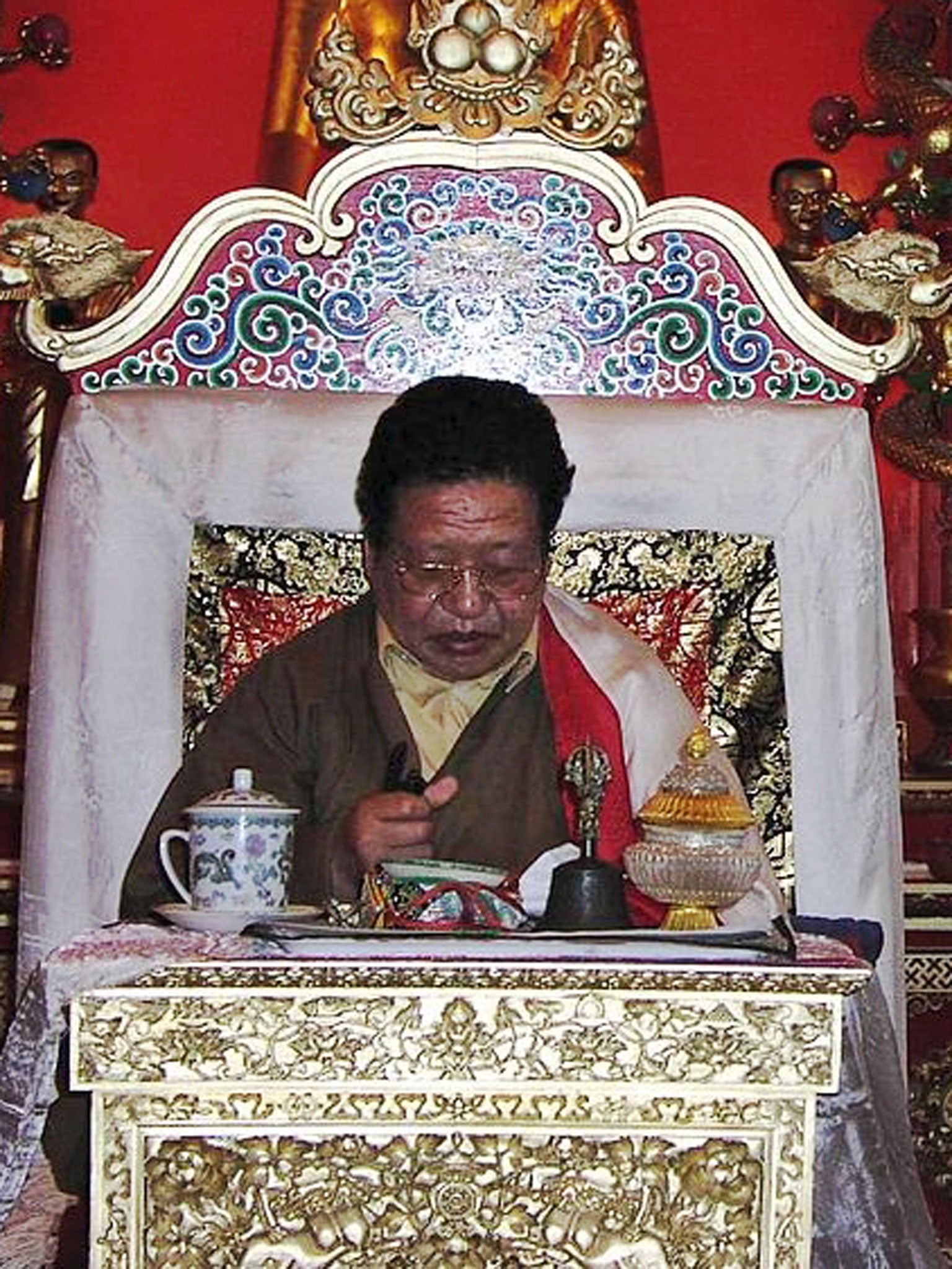 Akong Rinpoche on a throne at Samye Ling. The British Tibetan monk has been assassinated in China, according to police.