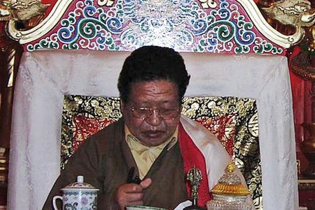 Akong Rinpoche on a throne at Samye Ling. The British Tibetan monk has been assassinated in China, according to police. 