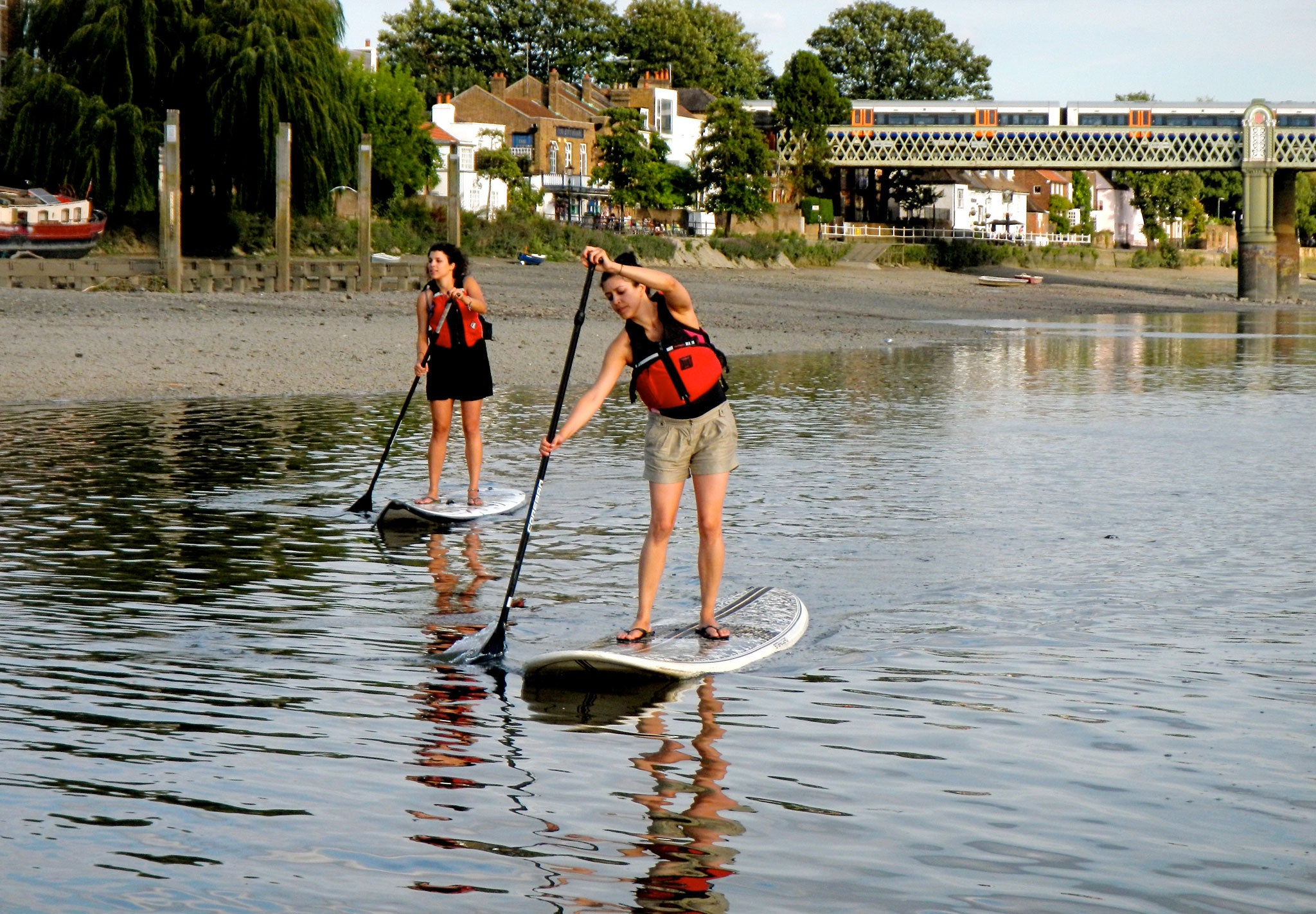 Two paddleboarders venture down the Thames for an alternative workout