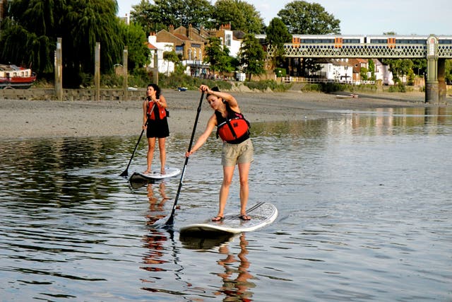 Two paddleboarders venture down the Thames for an alternative workout
