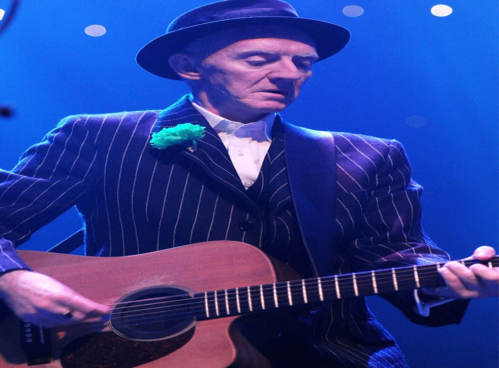 Phil Chevron performing with The Pogues in 2011