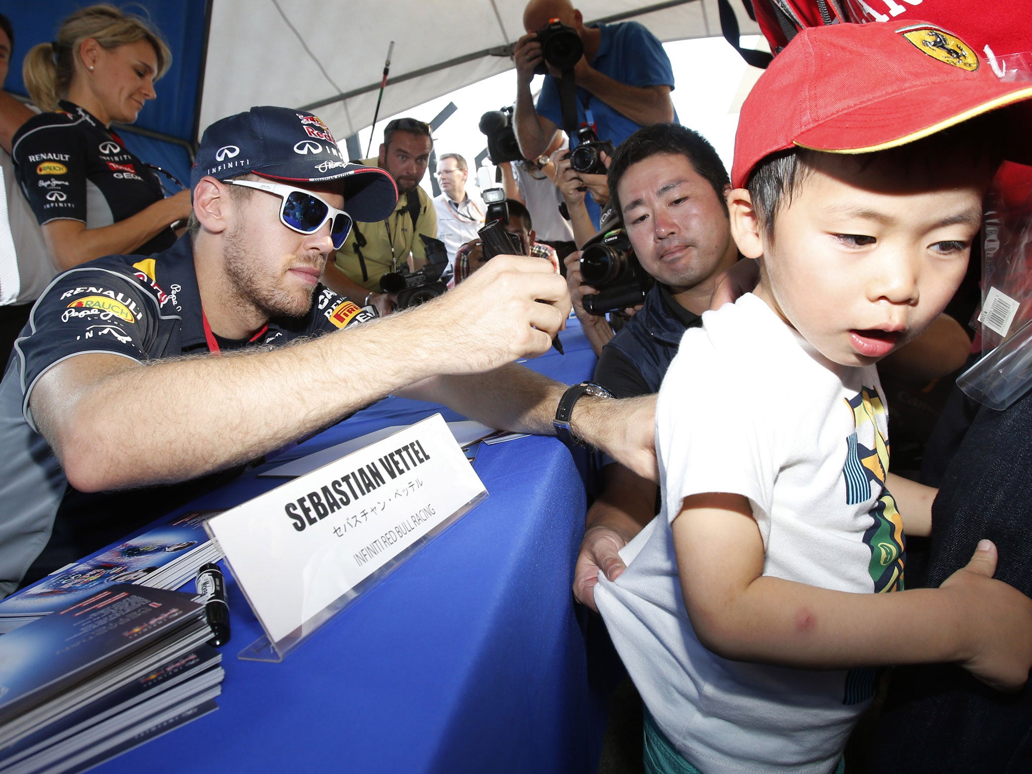 Sebastian Vettel signs autographs for fans at Suzuka