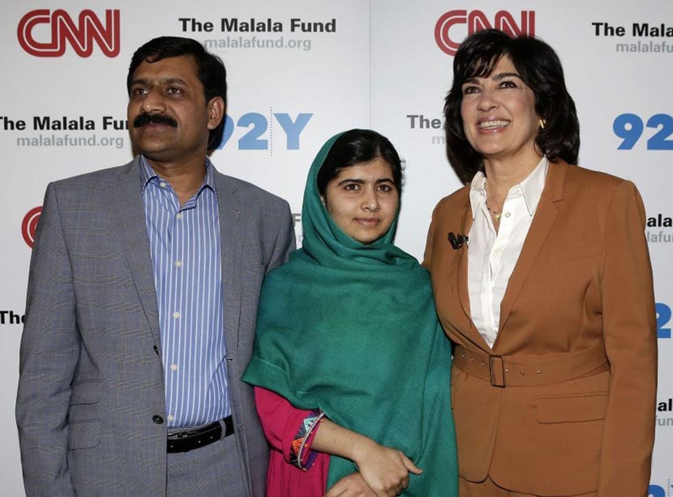 Malala Yousafzai with her father Ziauddin the Pakistani teenage advocate for female education who survived a Taliban assassination attempt, pose for photographers with CNN's Christiane Amanpour before a television interview in New York