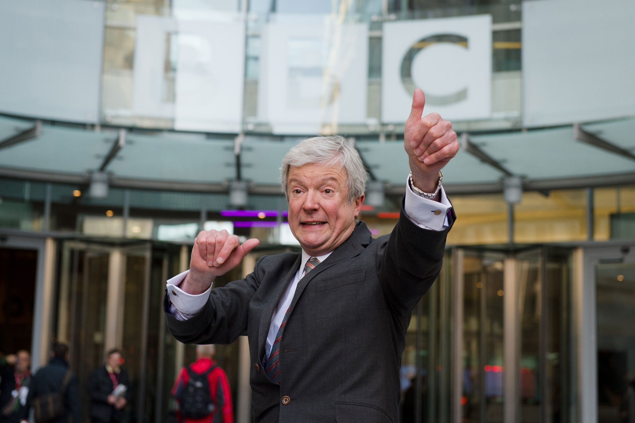 Tony Hall gestures outside the BBC as he arrives for his first day of work