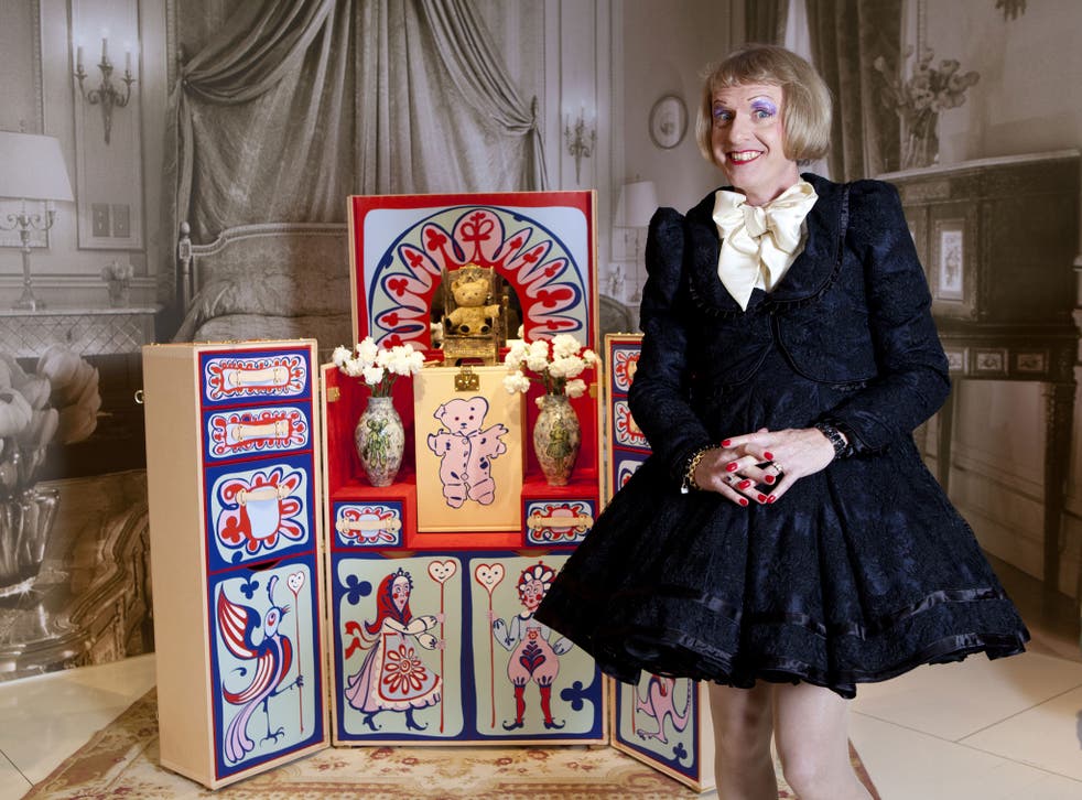 Grayson Perry with the Louis Vuitton trunk he designed, including a replica of his childhood teddy bear Elton