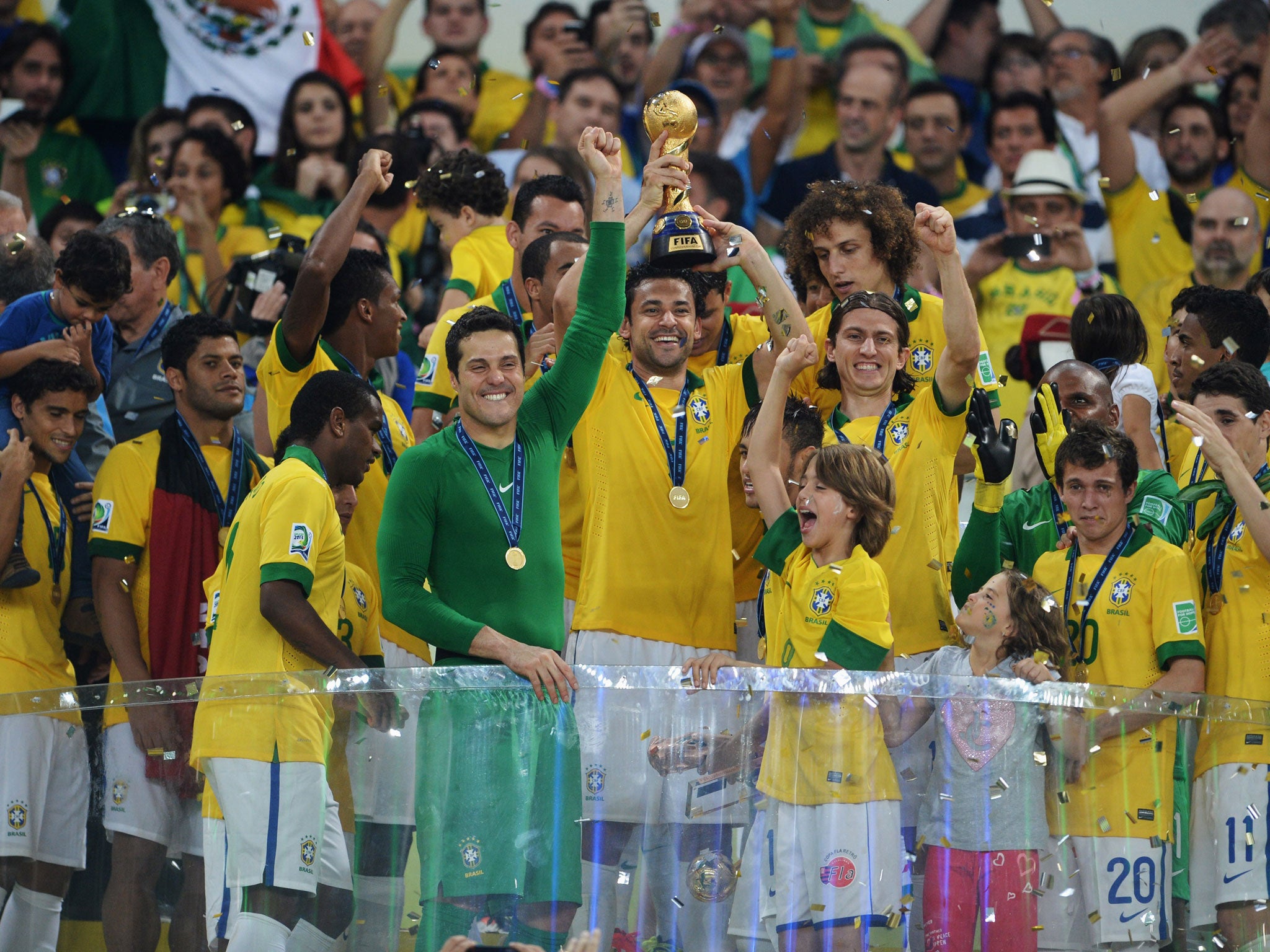 Fred lifts the Confederations Cup for Brazil after their final victory over Spain in Rio in June