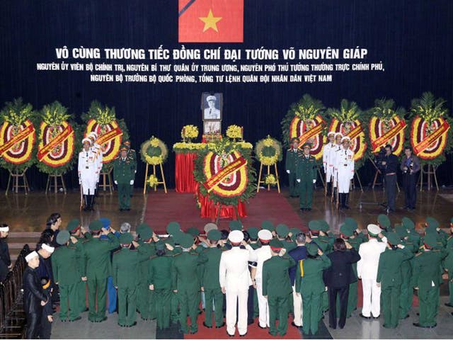 This handout picture taken on October 12, 2013 by the Vietnam News Agency shows a military delegation paying respects in front of the late General Vo Nguyen Giap's coffin at the National Funeral House in Hanoi. Vietnam's top leaders gathered to pay their last respects to independence hero General Vo Nguyen giap, who died last week