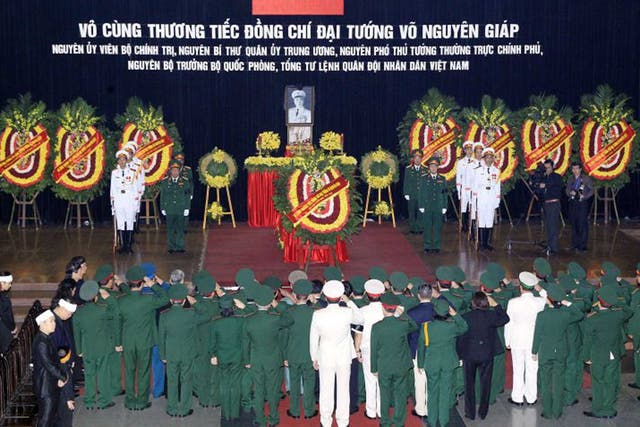 This handout picture taken on October 12, 2013 by the Vietnam News Agency shows a military delegation paying respects in front of the late General Vo Nguyen Giap's coffin at the National Funeral House in Hanoi. Vietnam's top leaders gathered to pay their last respects to independence hero General Vo Nguyen giap, who died last week