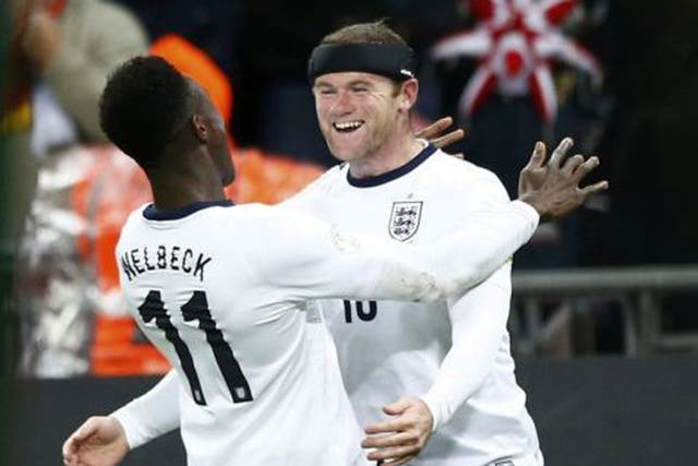Opening salvo: Wayne Rooney celebrates with Danny Welbeck after he scored England’s first goal against Montenegro on Friday night reuters
