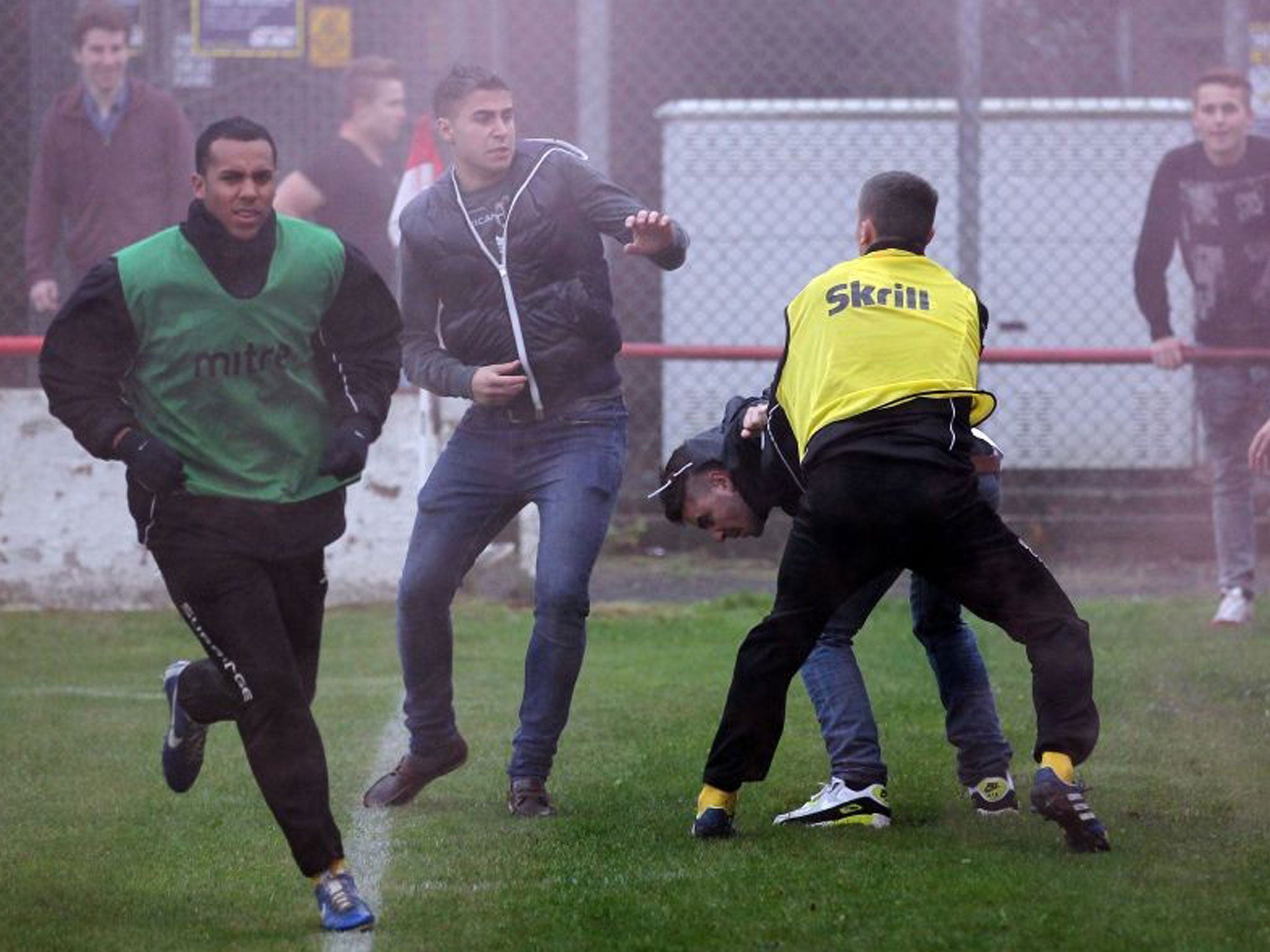 Crowd trouble: Barrow substitute Greg Mills (left) is surrounded by fighting