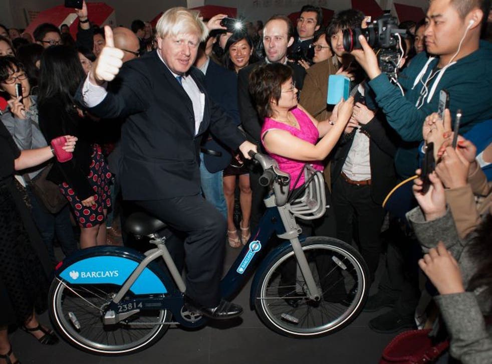 Boris Johnson begins a six-day trade mission to Beijing by posing on a  'Boris Bike'