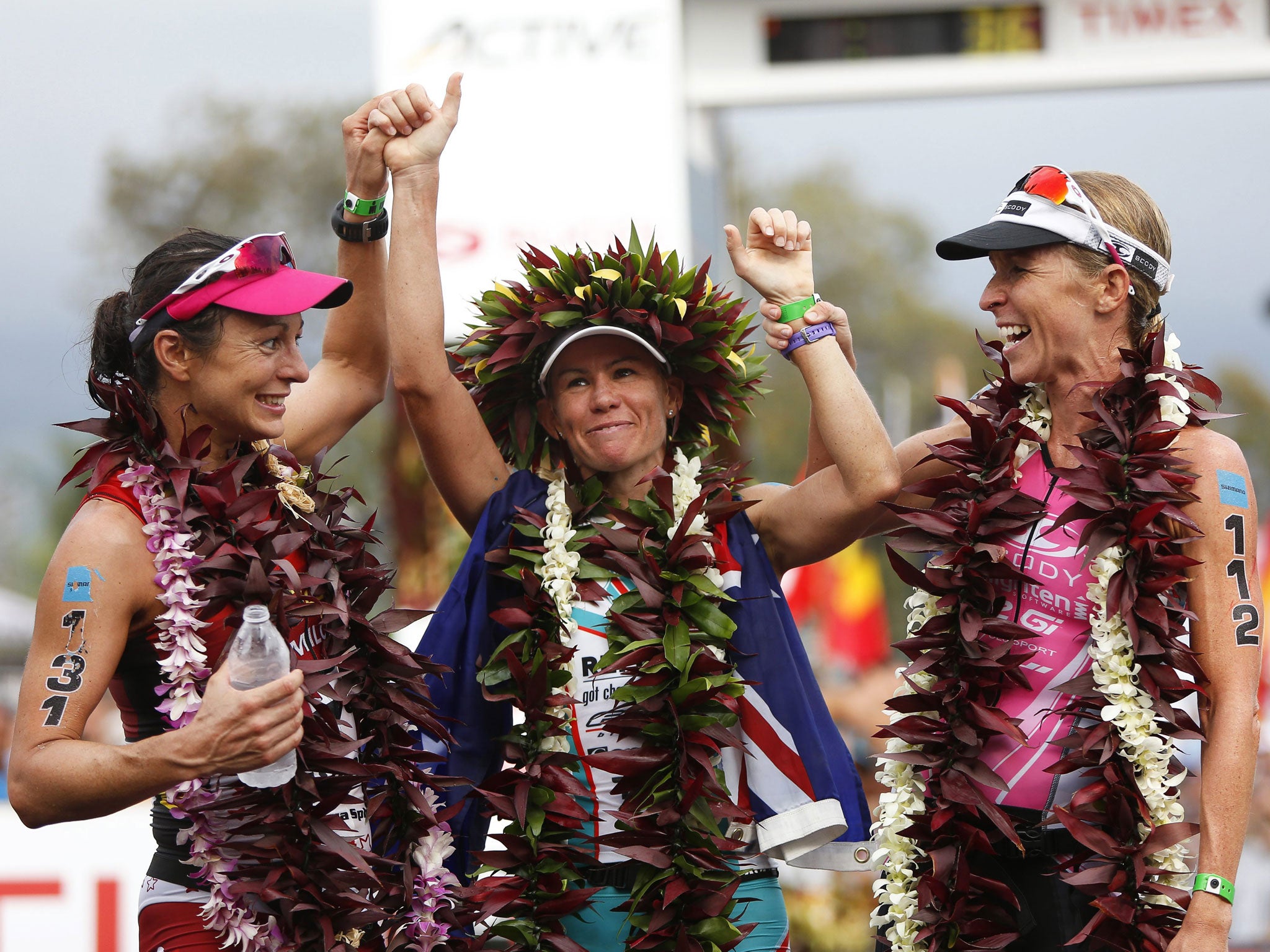 Mirinda Carfrae, centre, of Australia celebrates after winning the Ironman World Championships 2013 in Kailua-Kona, Hawaii. Carfrae won with a time of 08:52:14 h ahead of second placed Rachel Joyce, left, and third placed Liz Blatchford, right, both from