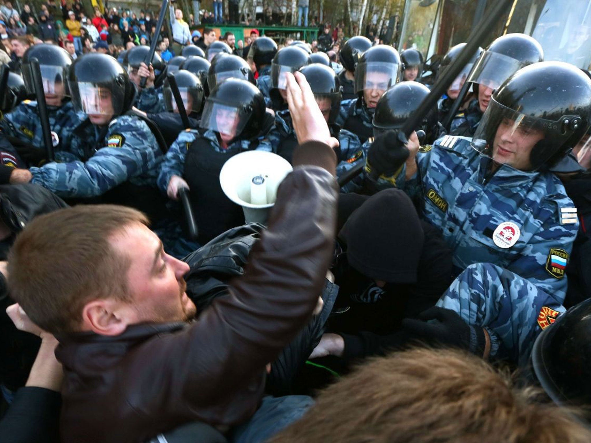 Riot police held back protestors in the southern Biryulyovo of Moscow as violence broke out following the murder of an ethnic Russian, blamed on a migrant from the Caucasus