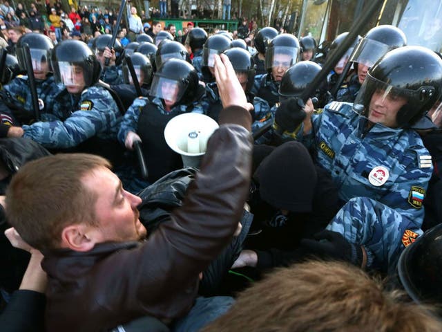 Riot police held back protestors in the southern Biryulyovo of Moscow as violence broke out following the murder of an ethnic Russian, blamed on a migrant from the Caucasus 