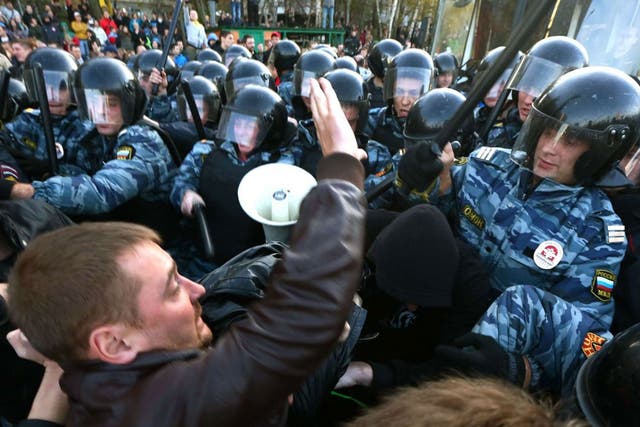 Riot police held back protestors in the southern Biryulyovo of Moscow as violence broke out following the murder of an ethnic Russian, blamed on a migrant from the Caucasus 