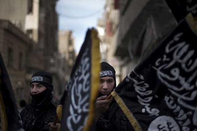 Members of the Islamist Liwa (brigade) Hamzah hold flags of Jebhat al-Nusra at a rally in Deir Ezzor earlier this year 