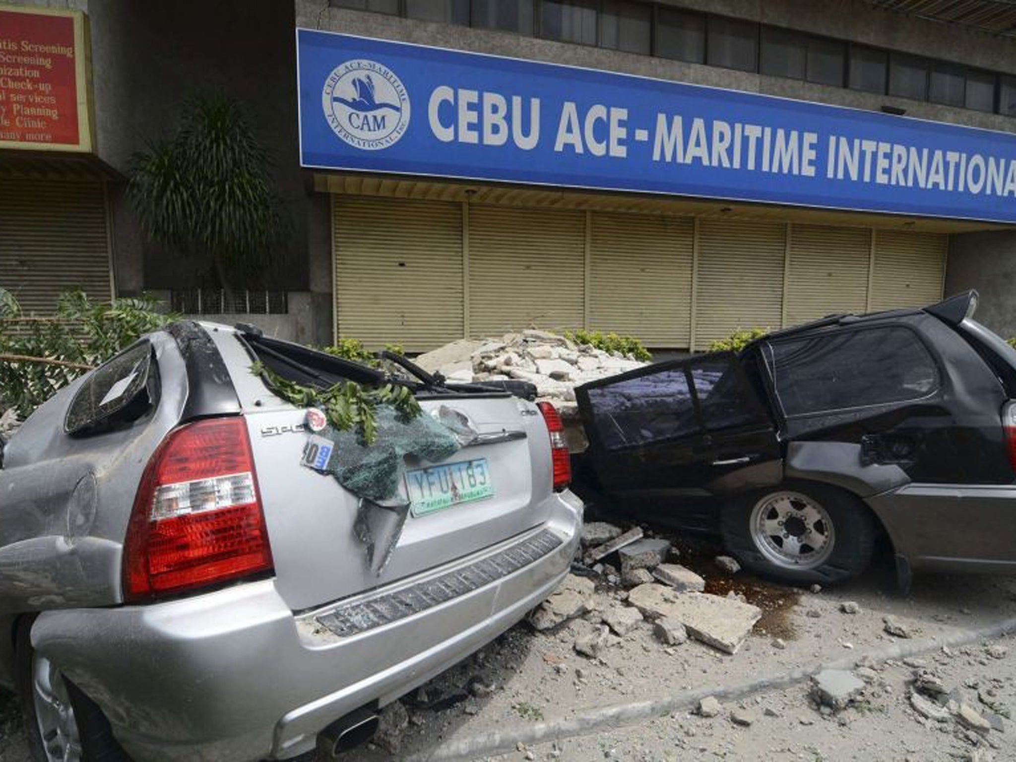Vehicles damaged by falling debris after an earthquake struck Cebu city