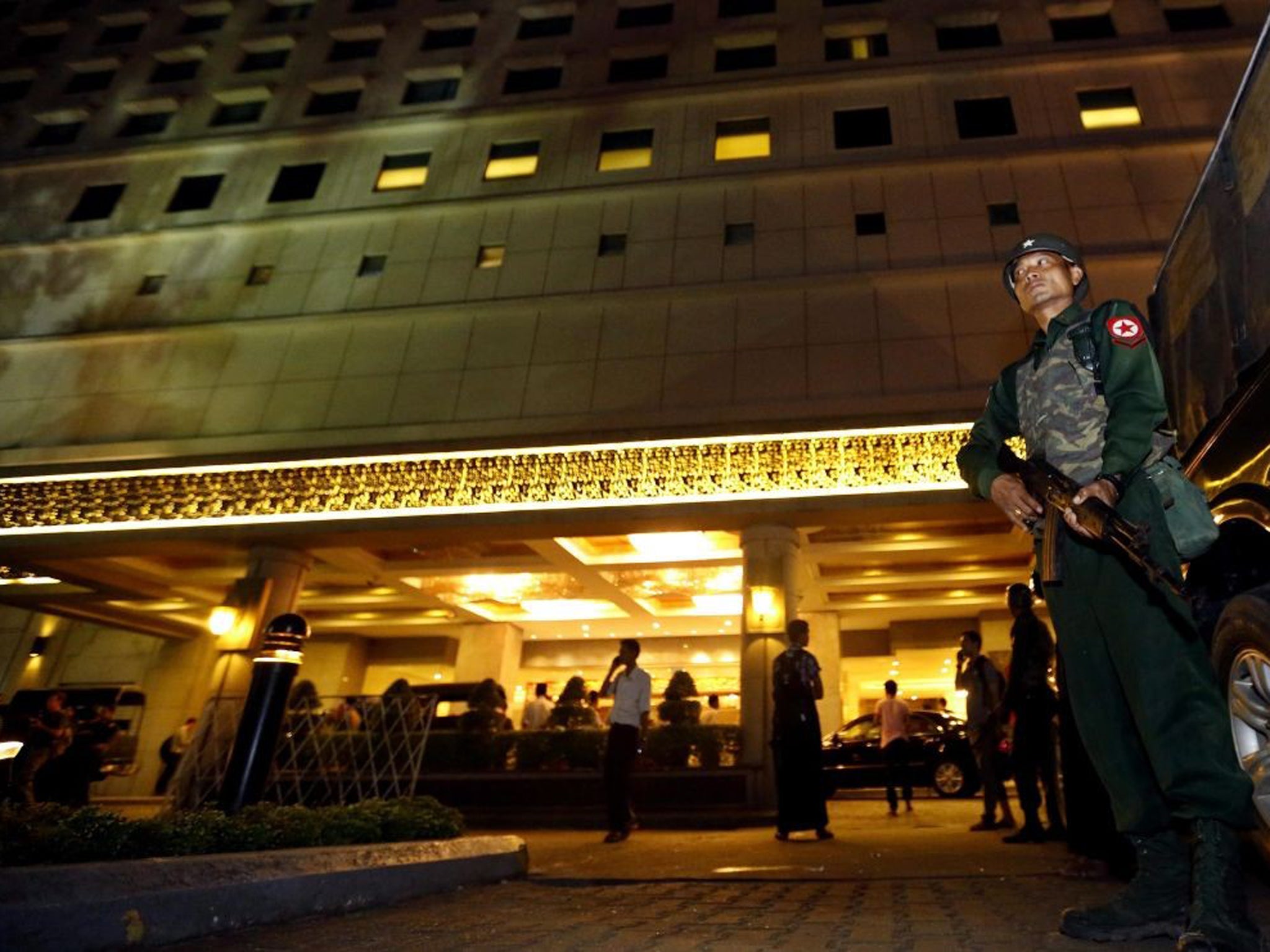 A soldier stands guard in front of the Traders Hotel after the explosion