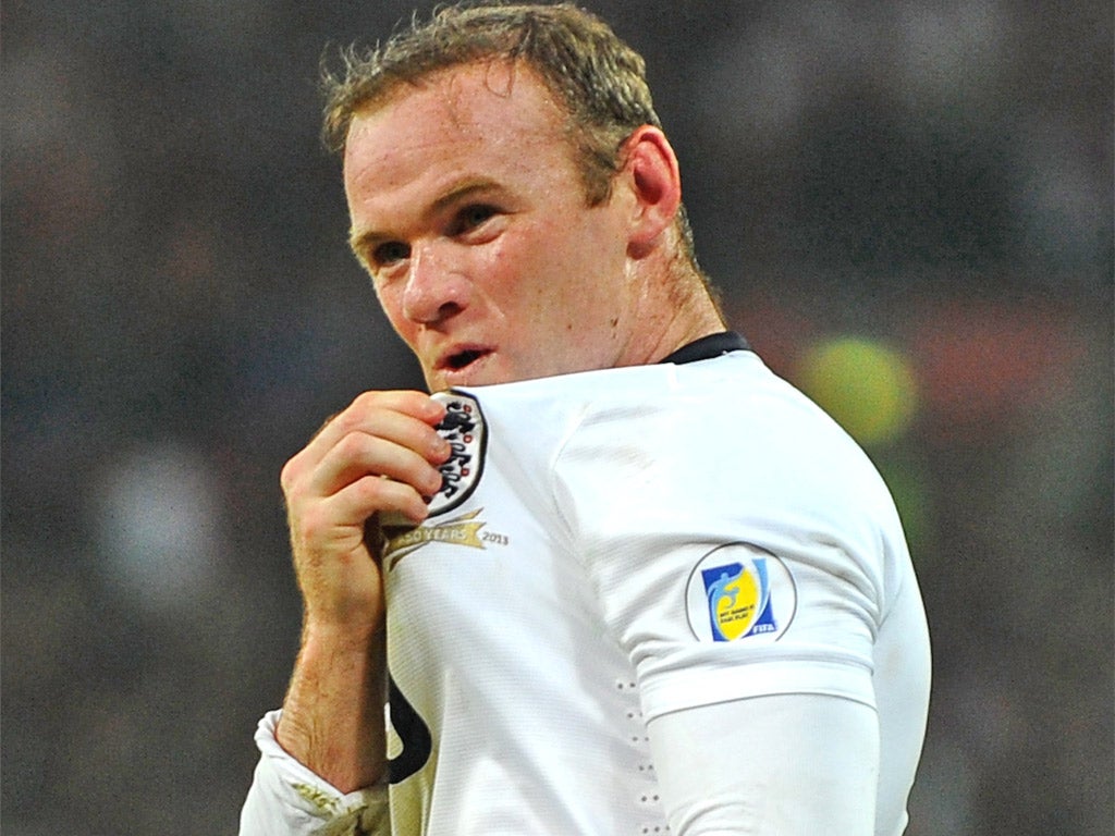 Wayne Rooney kisses the Three Lions after scoring on Wednesday