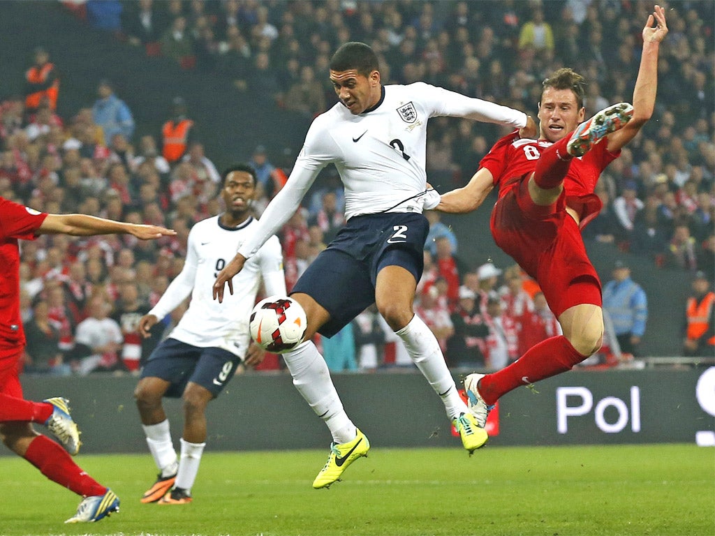 Chris Smalling is challenged by Grzegorz Krychowiak