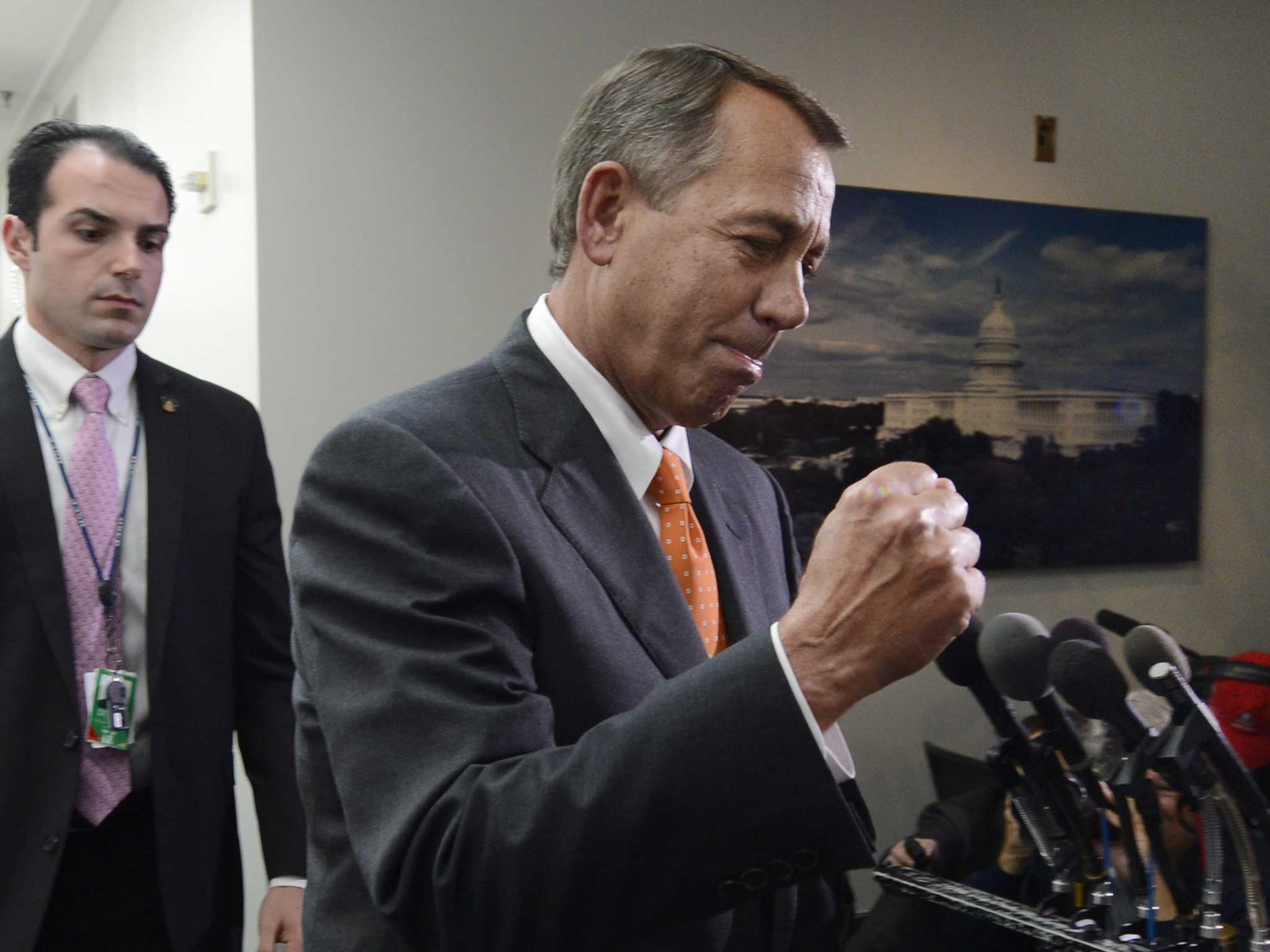 US House Speaker, Republican John Boehner pumps his fist following a House Republican conference meeting