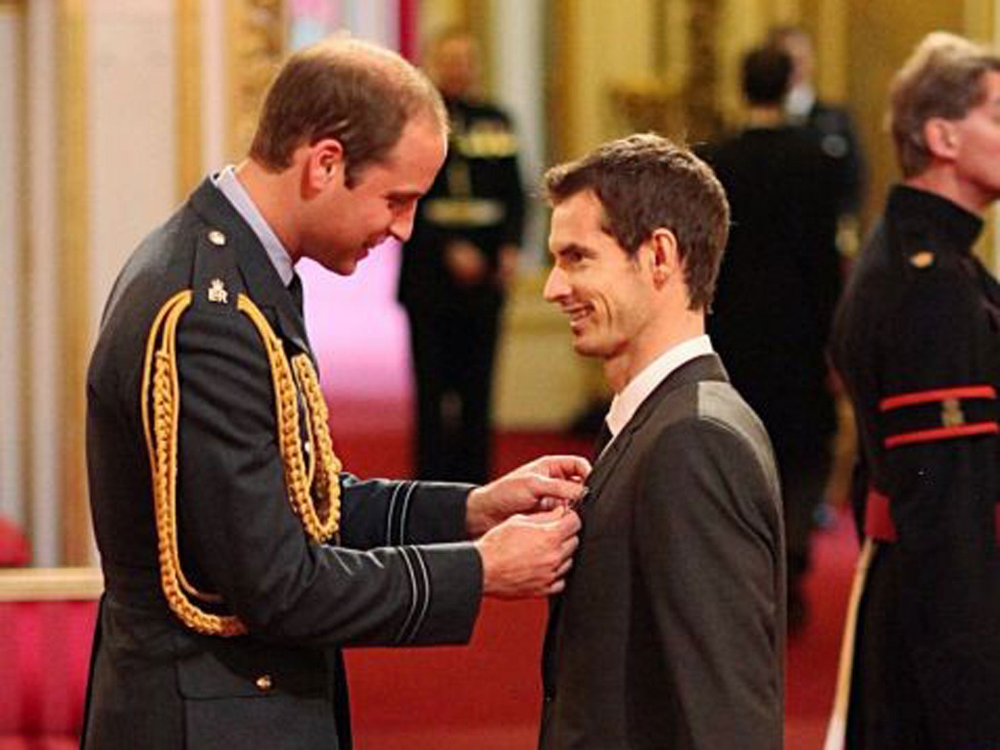 Wimbledon champion Andy Murray receives his OBE medal from Prince William at Buckingham Palace