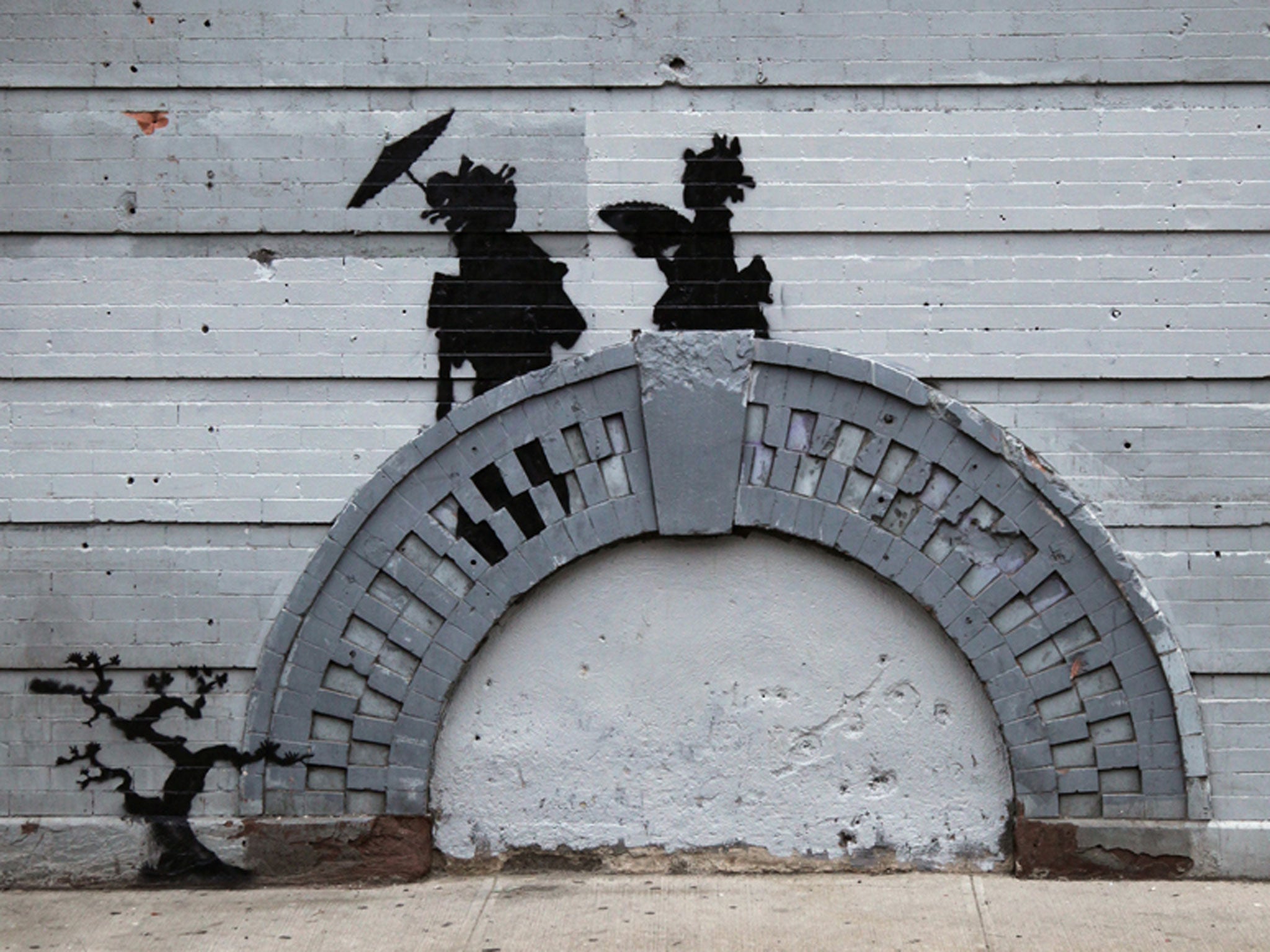 A metal gate has been installed to protect this Banksy in Brooklyn