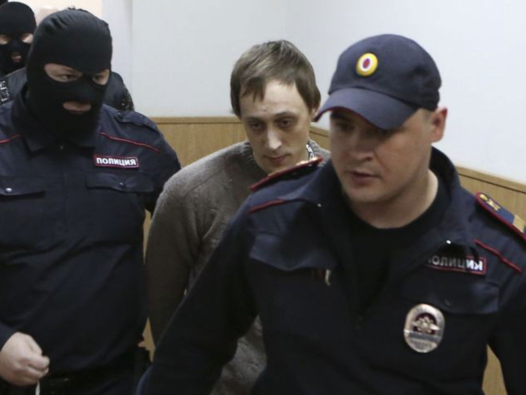Former Bolshoi Ballet lead soloist Pavel Dmitrichenko is escorted before a court session in Moscow on 16 October 16