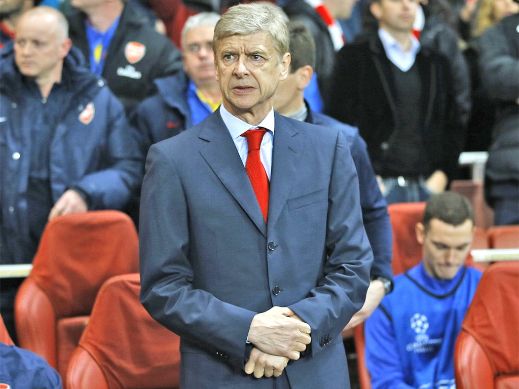 A concerned Arsene Wenger watches on