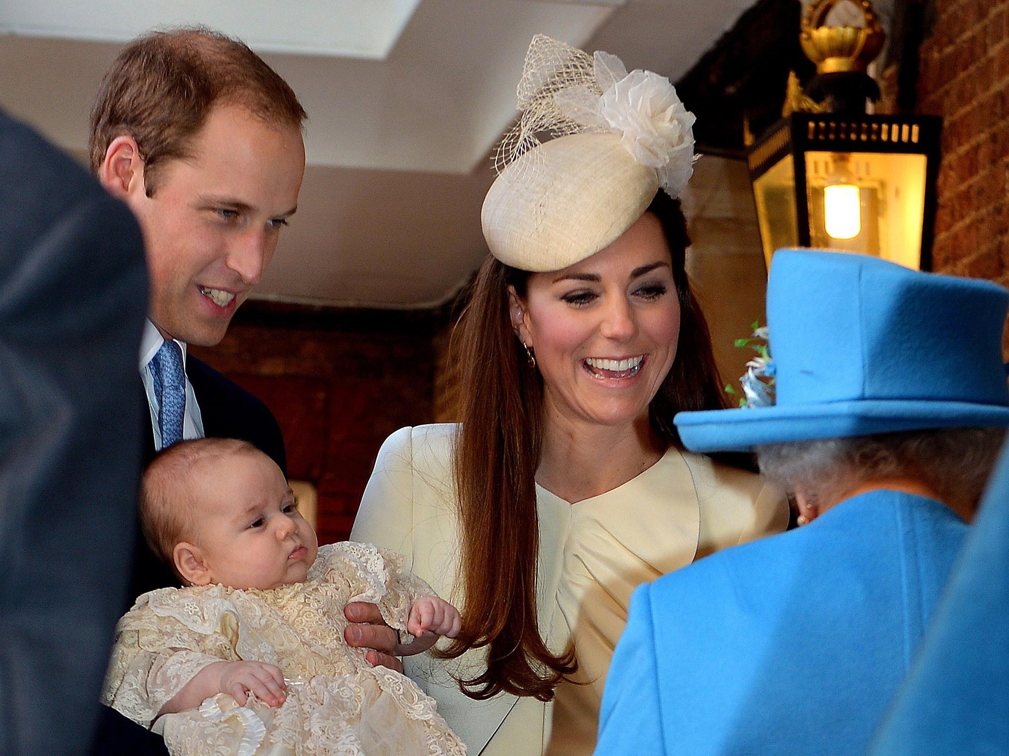 Britain's Prince William, Duke of Cambridge and his wife Catherine, Duchess of Cambridge, speak with Queen Elizabeth II as they hold their son Prince George of Cambridge at Chapel Royal in St James's Palace