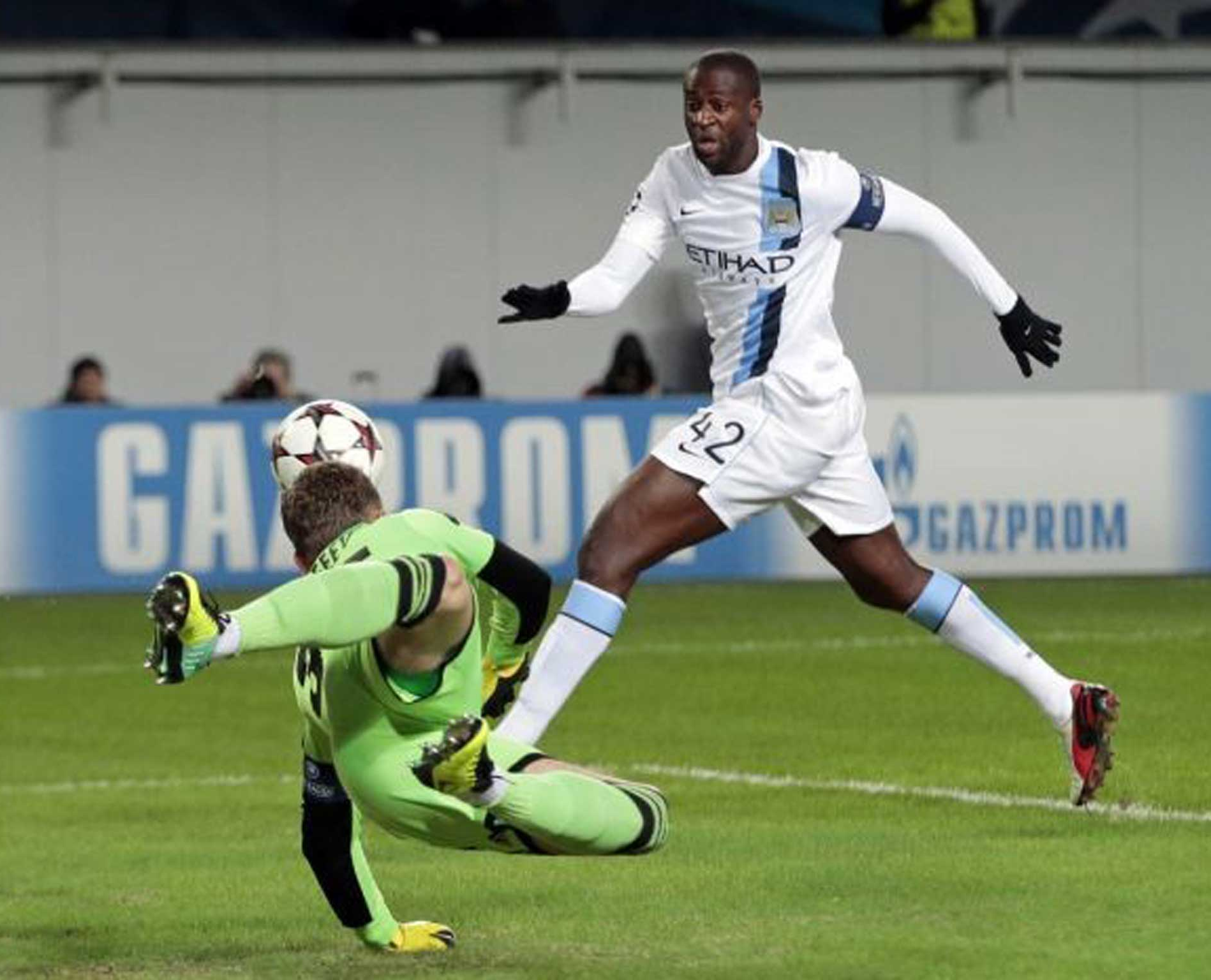 Yaya Toure, right, closes in on the ball as Moscow goalkeeper Igor Akinfeev dives
