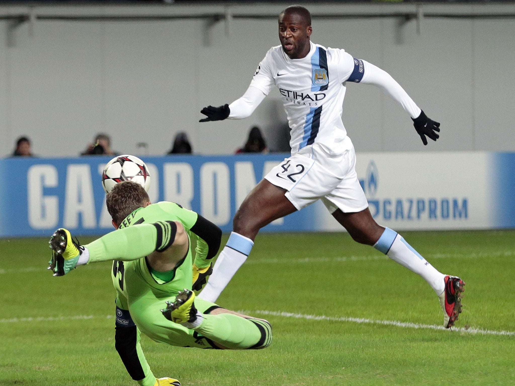 Manchester City's Yaya Toure, closes in on the ball as Moscow goalkeeper Igor Akinfeev dives