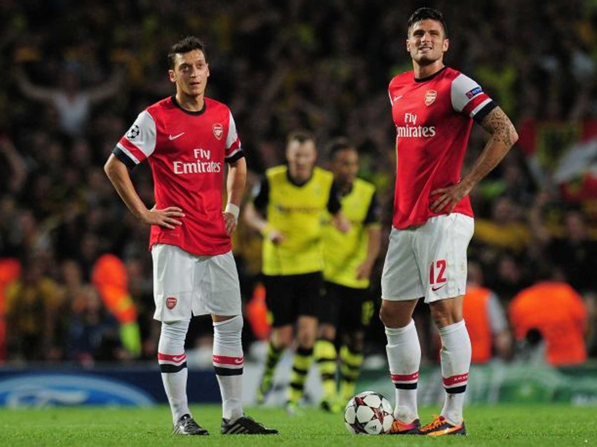 Mesut Özil (right) feels the pain of defeat on Tuesday