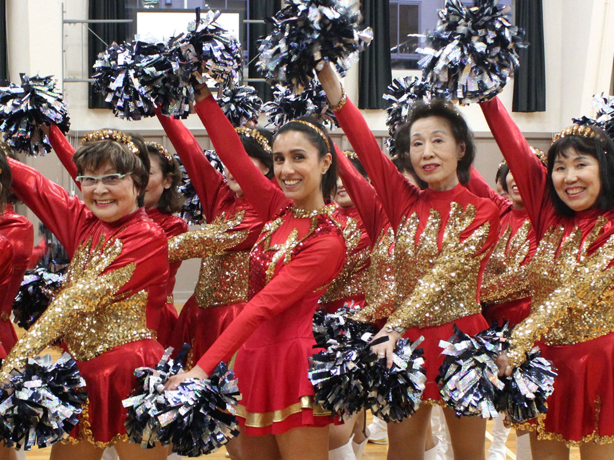 Anita Rani with Japan's senior cheerleading team in No Sex Please, We're Japanese