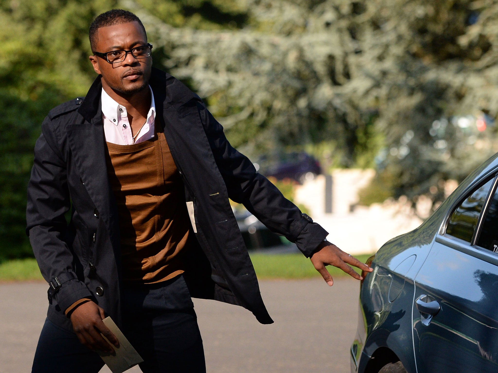 French forward Patrice Evra arrives at the French national football team's training base in Clairefontaine-en-Yvelines