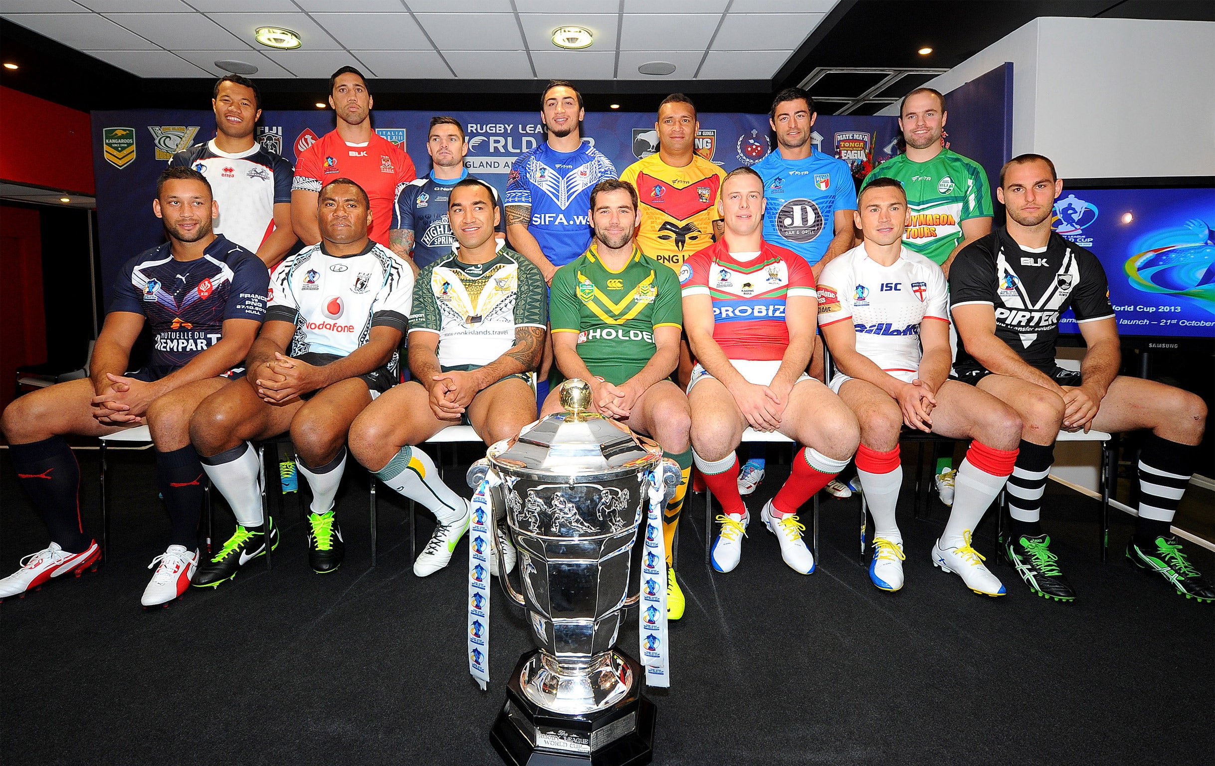 The captains from the 14 competing nations line up with the World Cup trophy