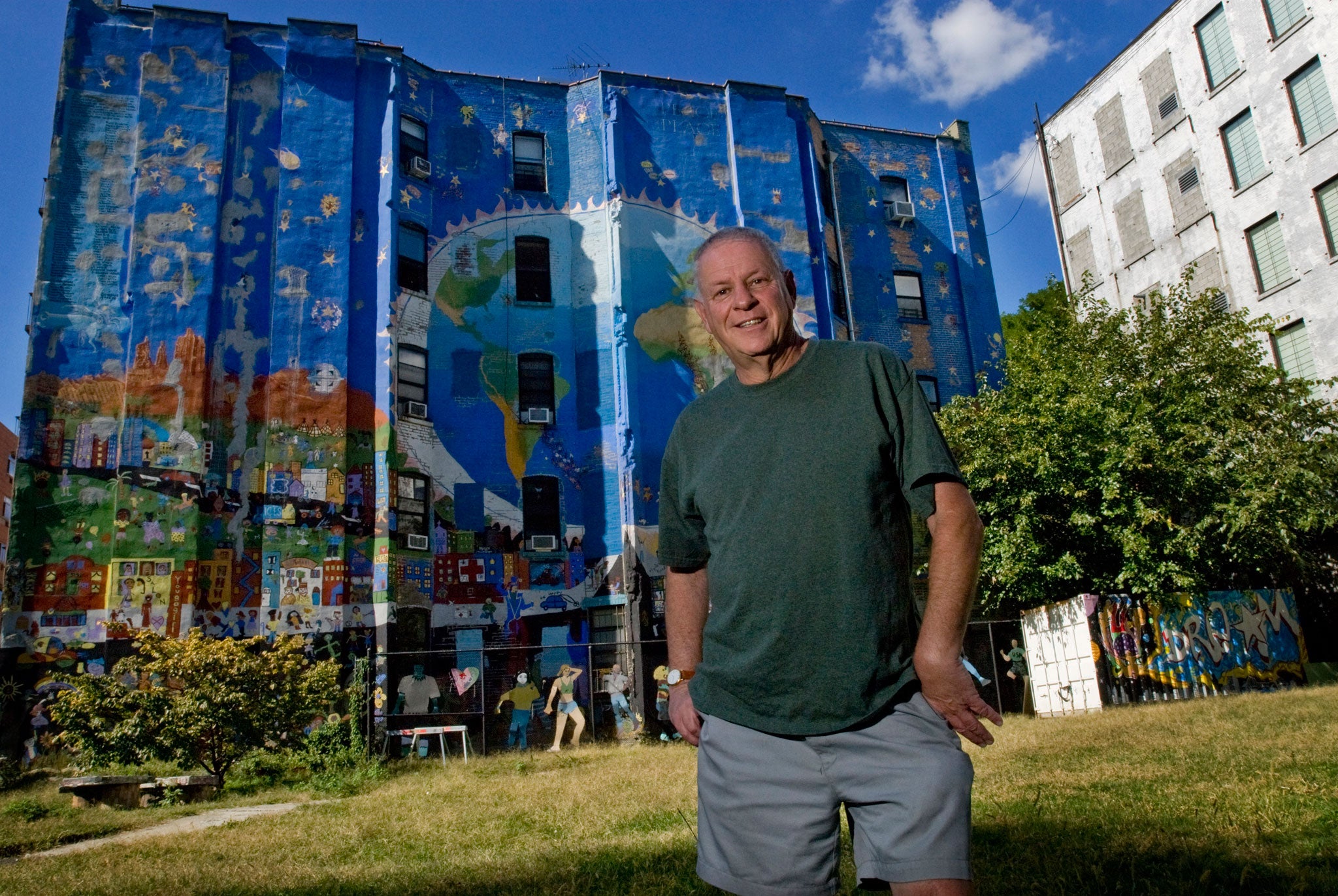 Helmreich in front of the Centro de La Paz mural in East Harlem