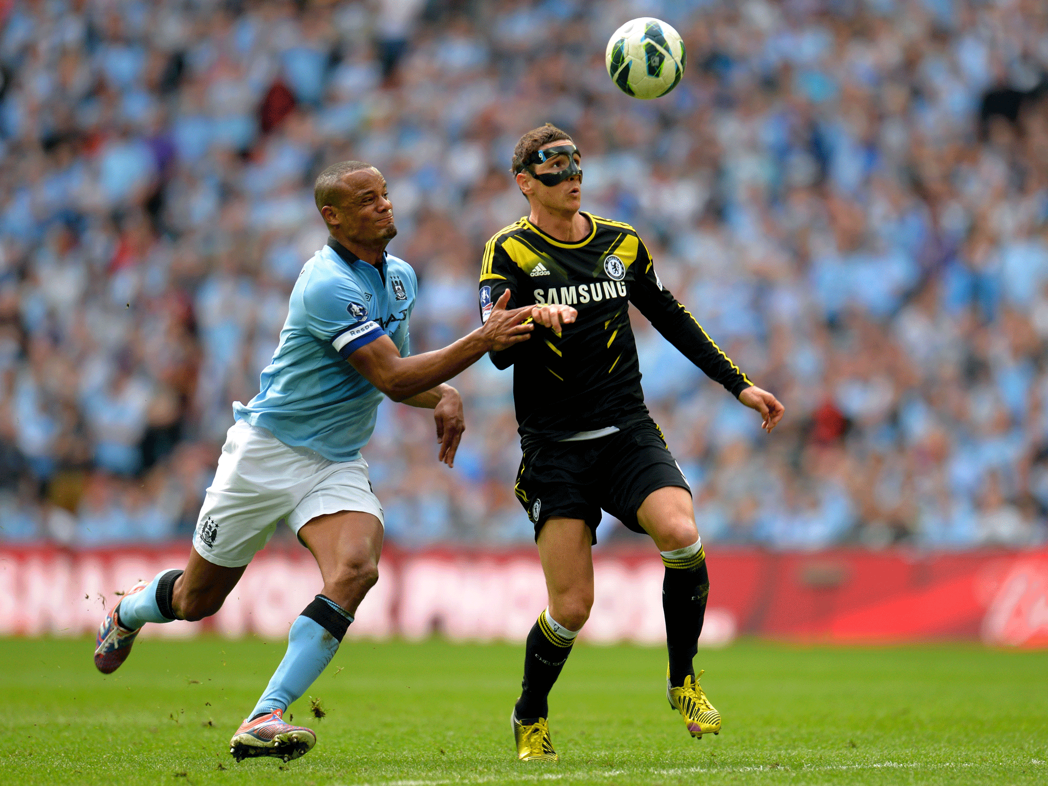 Vincent Kompany of Manchester City and Fernando Torres of Chelsea tussle for the ball